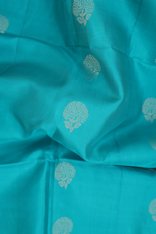 Soft Silk Saree In Greenish Blue With Floral Buttas