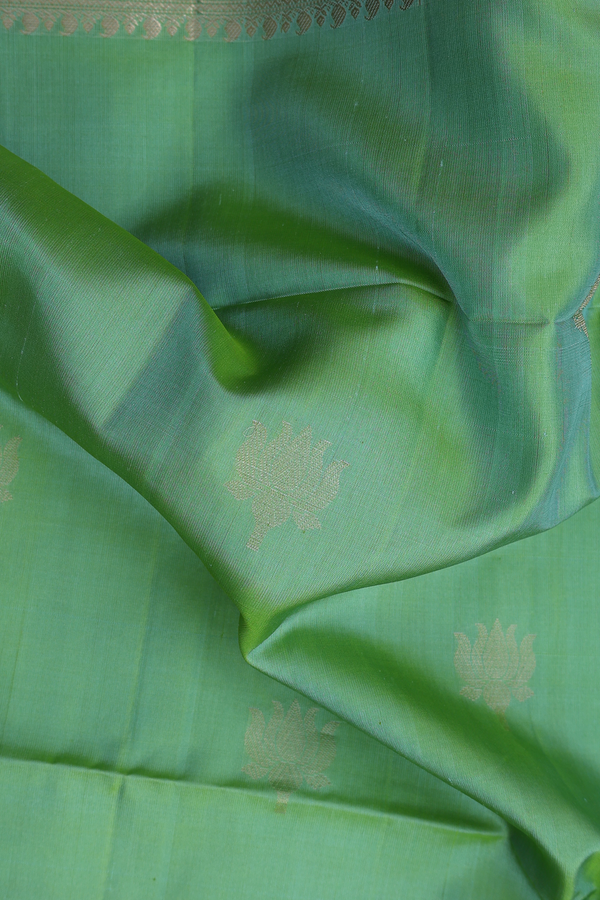 Soft Silk Saree In Moss Green With Floral Buttas