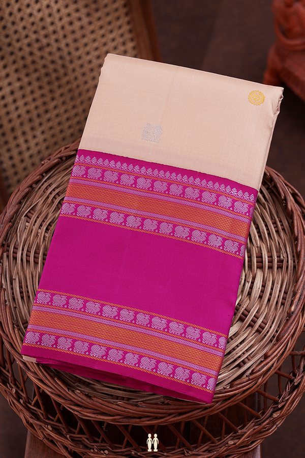 Kanchipuram Silk Saree In Creamy Orange With Peacock Buttas