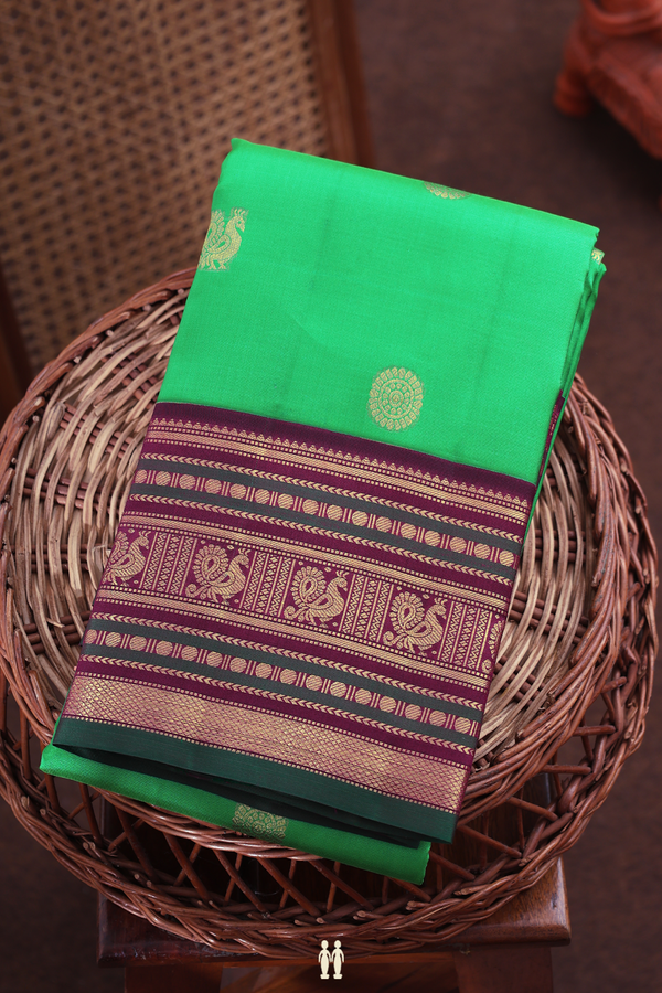 Kanchipuram Silk Saree In Green With Peacock Chakram Buttas