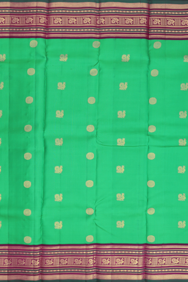 Kanchipuram Silk Saree In Green With Peacock Chakram Buttas