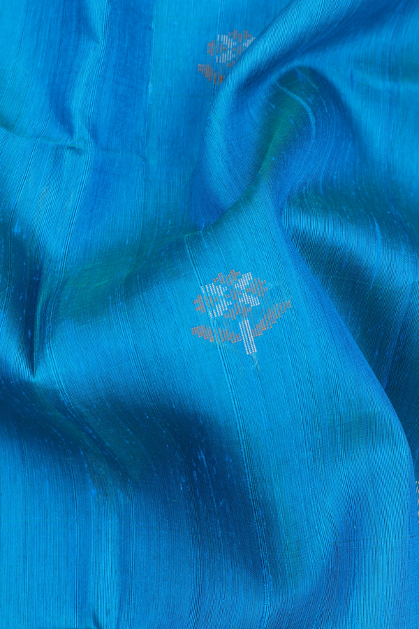 Raw Silk Saree In Blue With Floral Buttas