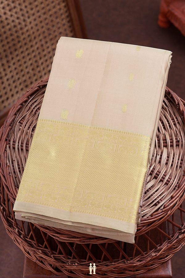 Kanchipuram Silk Saree In Cream Color With Peacock Buttas