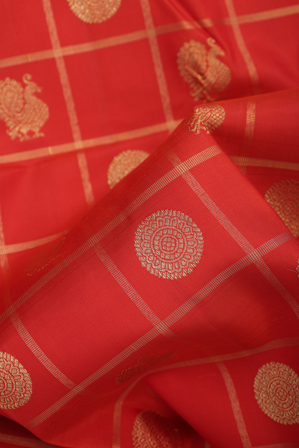 Kanchipuram Silk Saree In Orange Along Checks With Buttas
