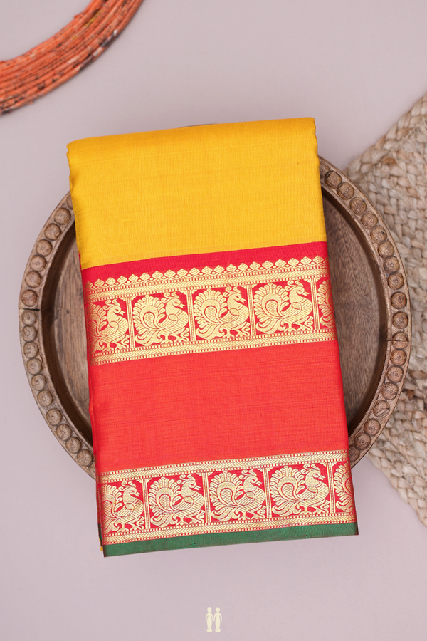 Kanchipuram Silk Saree In Plain Yellow With Peacock Border