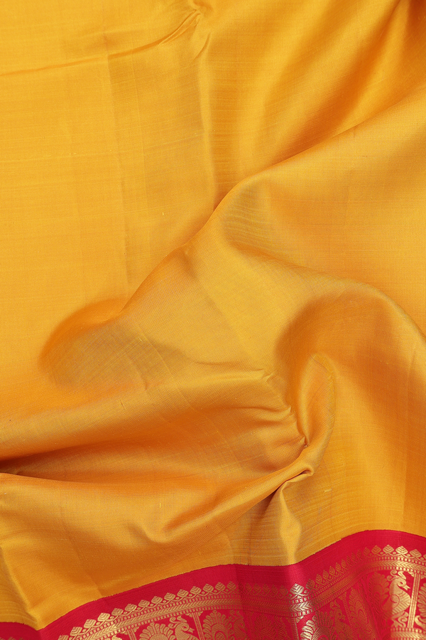 Kanchipuram Silk Saree In Plain Yellow With Peacock Border