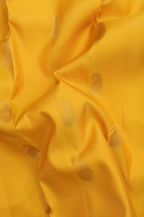 Kanchipuram Silk Saree In Saffron Yellow With Paisley Buttas