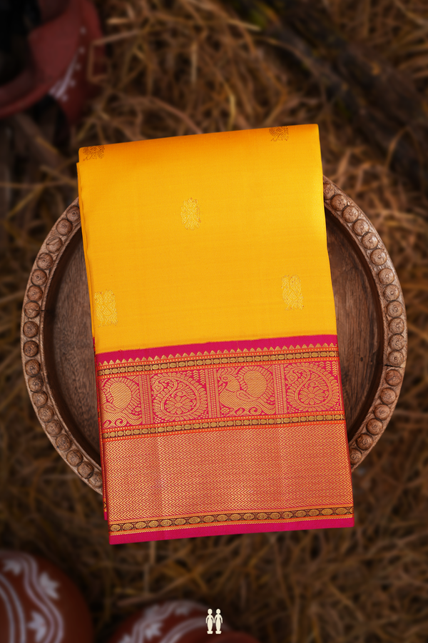 Kanchipuram Silk Saree In Saffron Yellow With Peacock Buttas