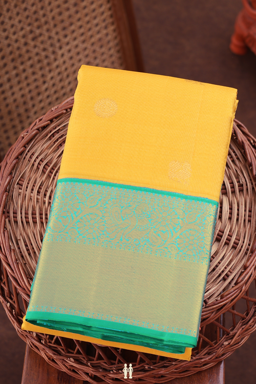 Kanchipuram Silk Saree In Saffron Yellow With Peacock Buttas
