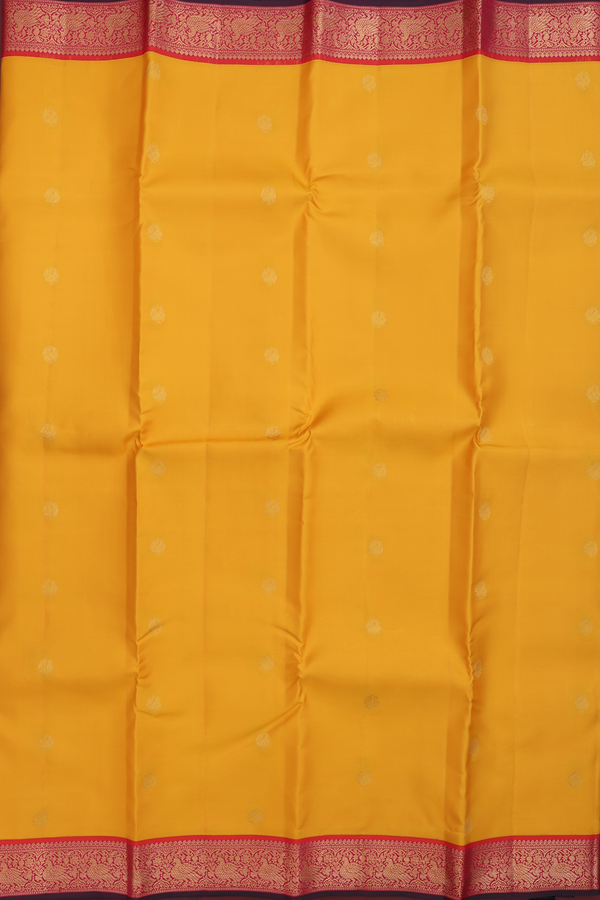 Kanchipuram Silk Saree In Saffron Yellow With Peacock Buttas