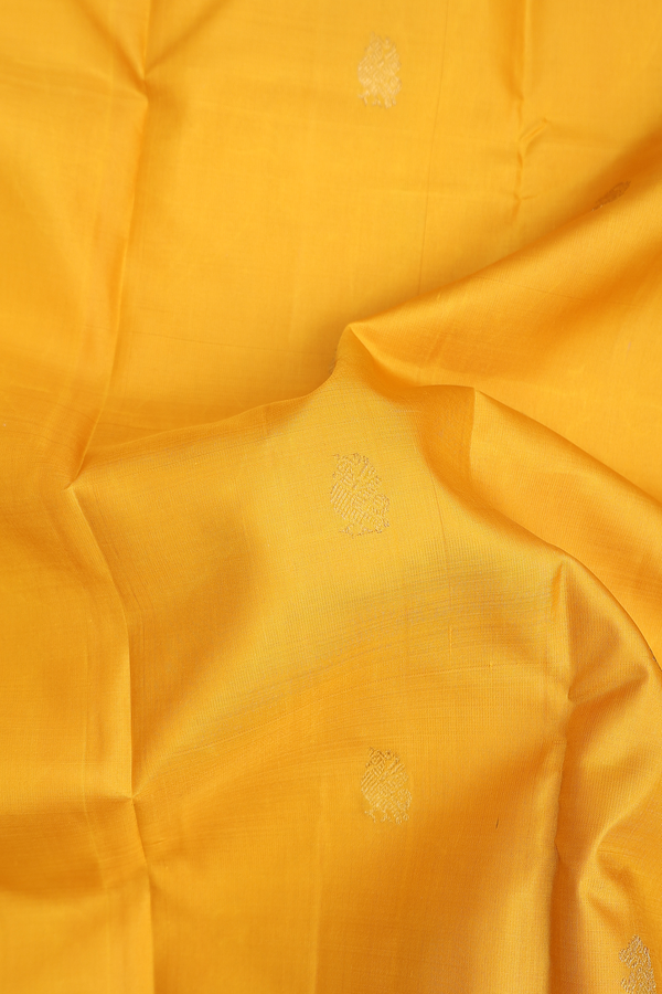 Kanchipuram Silk Saree In Saffron Yellow With Peacock Buttas