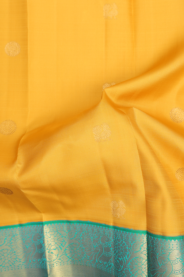 Kanchipuram Silk Saree In Saffron Yellow With Peacock Buttas