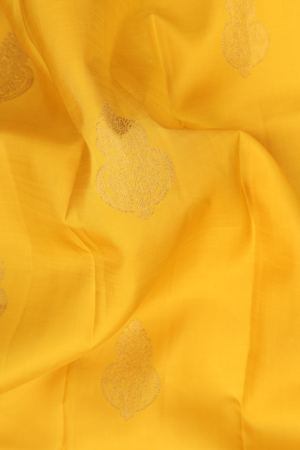 Kanchipuram Silk Saree In Saffron Yellow With Zari Buttas
