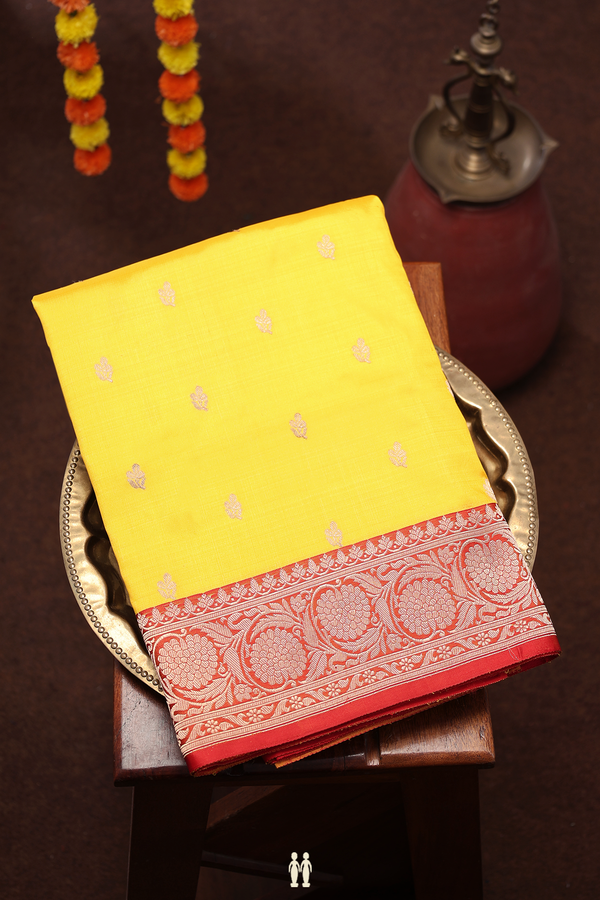 Banarasi Silk Saree In Saffron Yellow With Floral Buttas