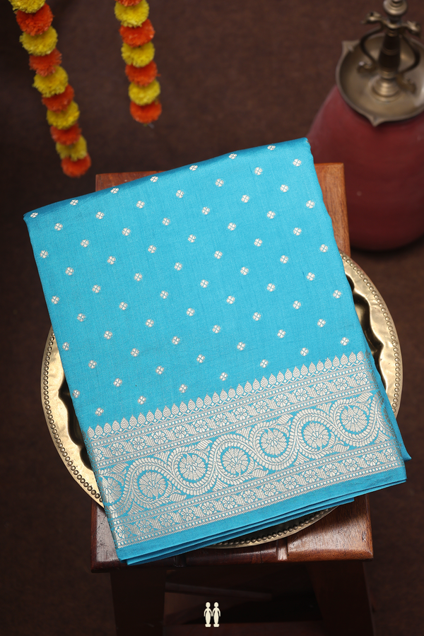 Raw Silk Saree In Deep Sky Blue With Floral Buttis