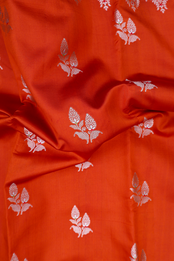 Raw Silk Saree In Rust Orange With Floral Buttas