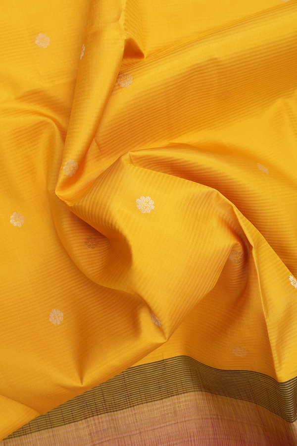 Soft Silk Saree In Saffron Yellow With Floral Buttas