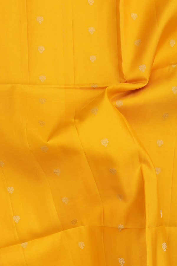 Soft Silk Saree In Saffron Yellow With Floral Buttis